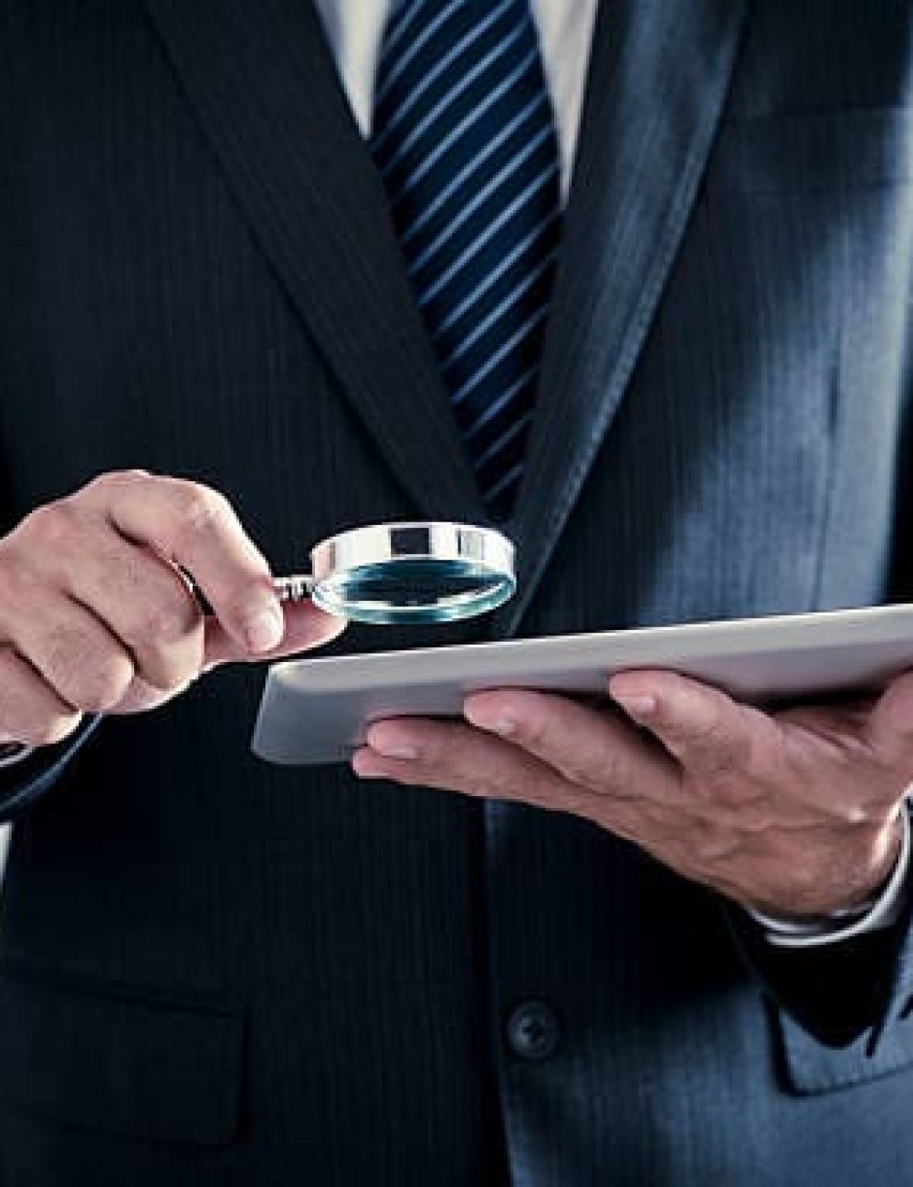 man looking at a paper Hire Investigator
